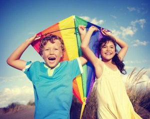 Cheerful Children Playing Kite Outdoors Concept